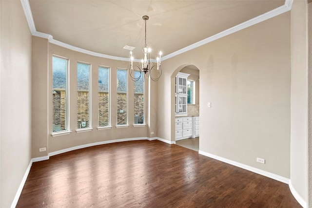 unfurnished dining area featuring plenty of natural light, crown molding, and dark wood-type flooring