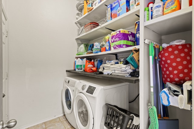 washroom with light tile patterned flooring and washing machine and clothes dryer