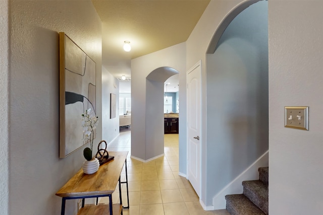 hall featuring light tile patterned floors