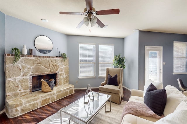 living room featuring ceiling fan, a fireplace, and hardwood / wood-style floors