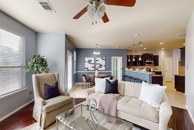 living room with light hardwood / wood-style flooring and a chandelier