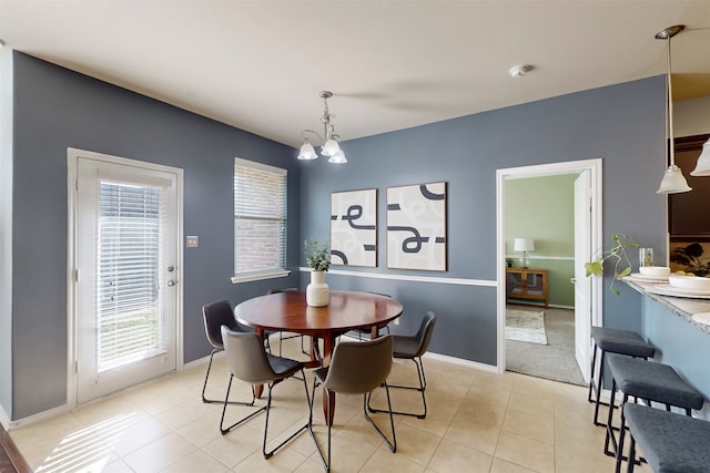 dining space with a notable chandelier and light tile patterned floors