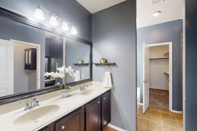 bathroom with tile patterned floors and vanity