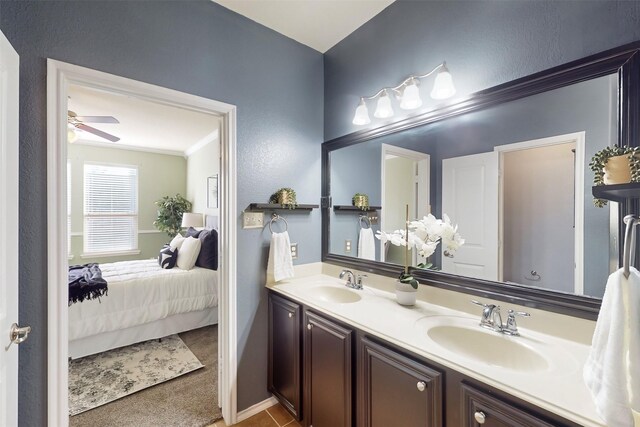 bathroom featuring ceiling fan, crown molding, and vanity