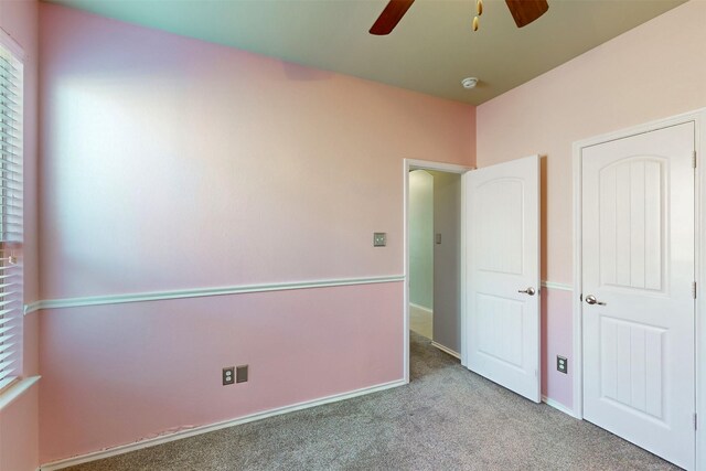 unfurnished bedroom with light carpet and ceiling fan