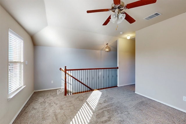 interior space with carpet, ceiling fan, and vaulted ceiling