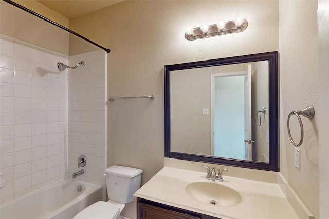 full bathroom with toilet, vanity, and tiled shower / bath