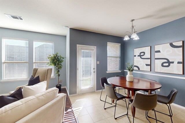 dining area featuring a notable chandelier and light tile patterned floors