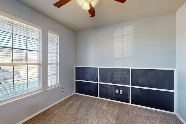 empty room featuring carpet flooring and ceiling fan