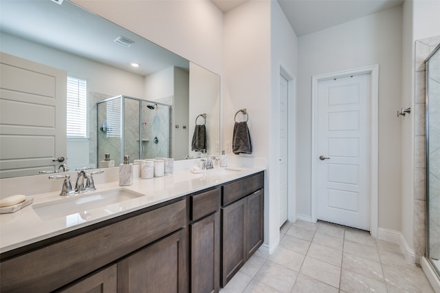 bathroom with walk in shower, vanity, and tile patterned flooring