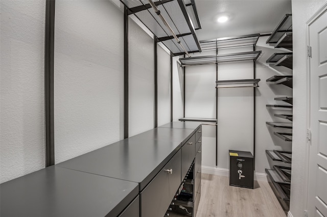 walk in closet with light wood-type flooring