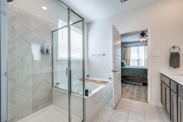 bathroom with independent shower and bath, vanity, tile patterned floors, and ceiling fan