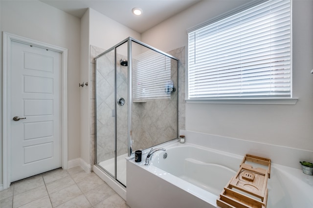 bathroom featuring tile patterned flooring and shower with separate bathtub