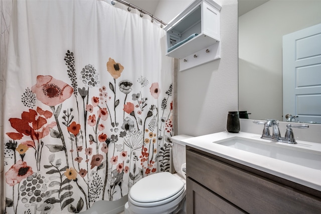 bathroom with vanity, toilet, and a shower with shower curtain