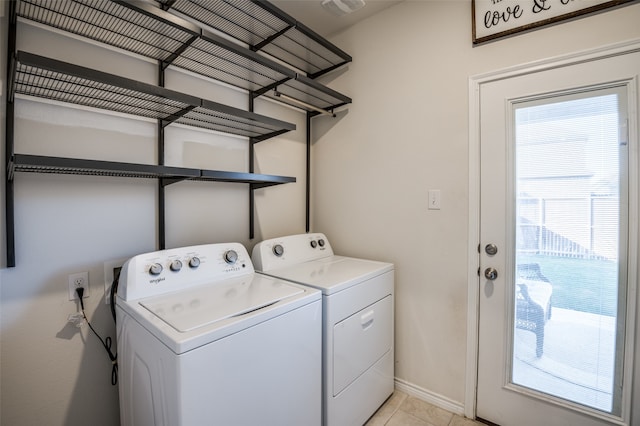 laundry room featuring washer and clothes dryer and light tile patterned floors