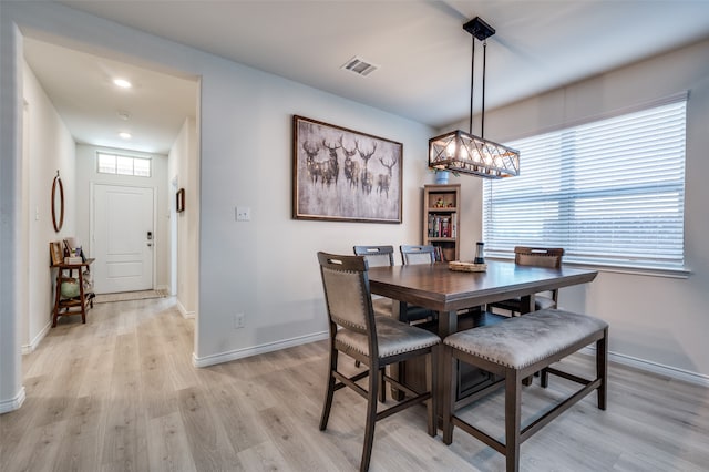 dining room featuring a healthy amount of sunlight and light hardwood / wood-style flooring