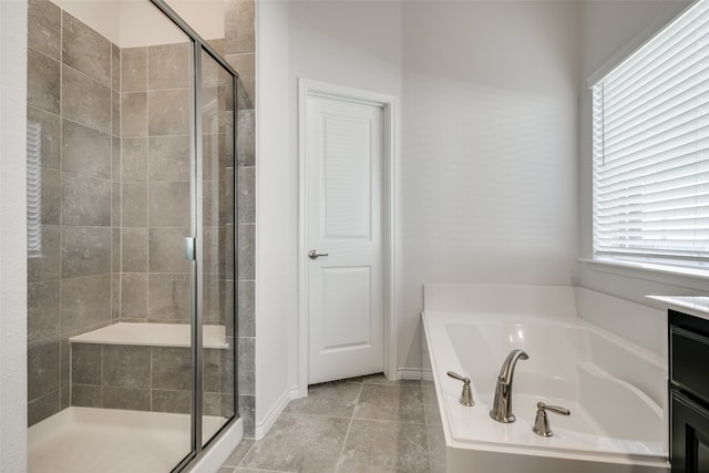 bathroom featuring tile patterned flooring, vanity, and separate shower and tub