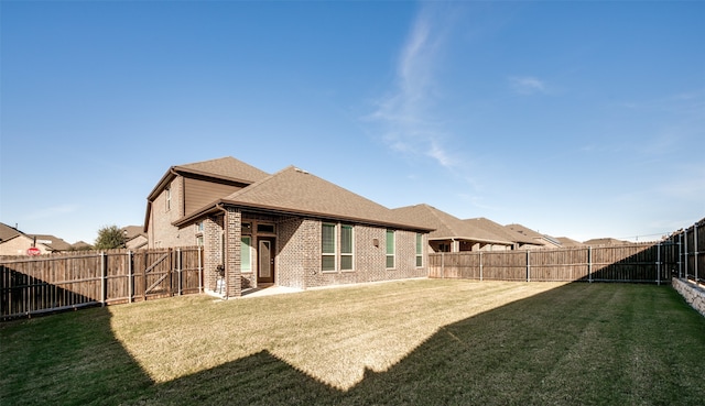 rear view of property featuring a yard