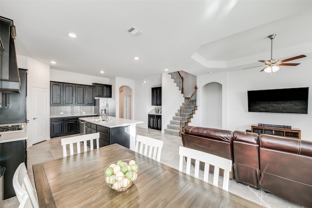 dining space with ceiling fan and light tile patterned flooring