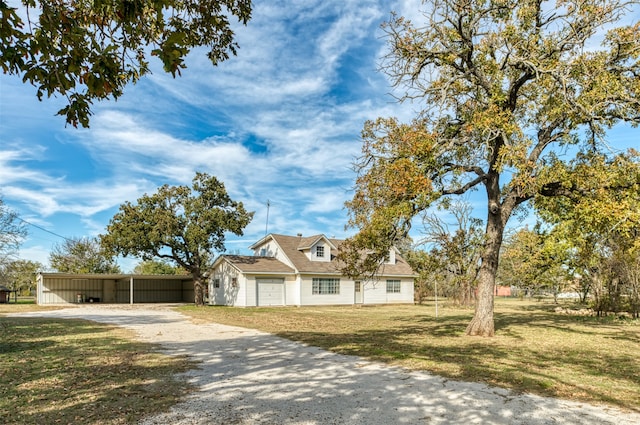 view of front of home with a front lawn and a carport