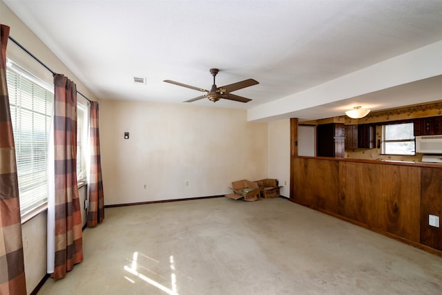 empty room with light carpet, plenty of natural light, and ceiling fan