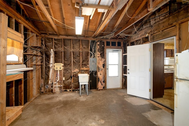 3533 Fir St, Weatherford, TX 76088 - below grade area with electric panel and freestanding refrigerator