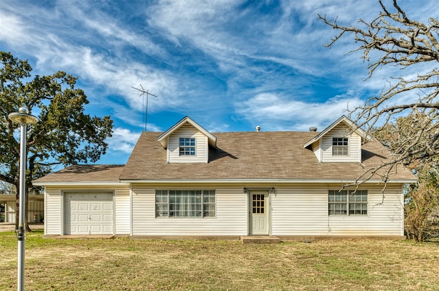 cape cod home featuring a front lawn and a garage