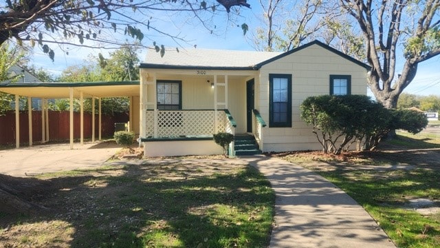 view of front of home featuring a carport and covered porch