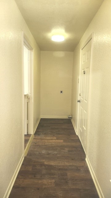 hallway with dark hardwood / wood-style flooring