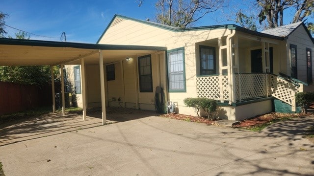 view of side of property with a carport