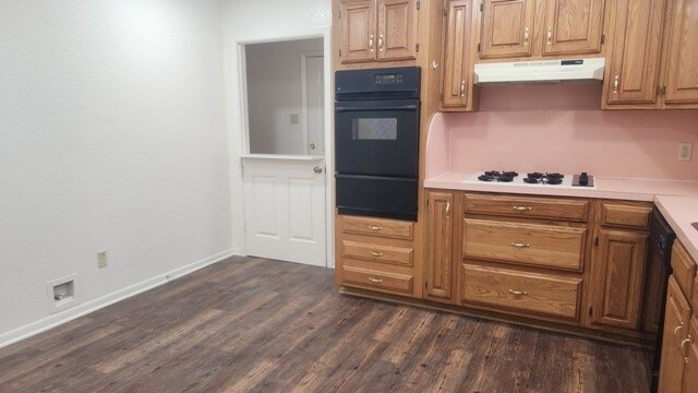 kitchen with dark hardwood / wood-style flooring and white gas cooktop