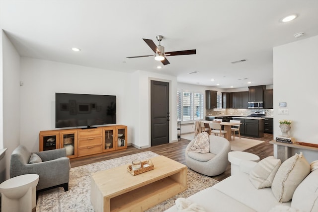 living room featuring ceiling fan and light wood-type flooring