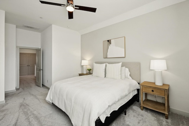 bedroom with ceiling fan and light carpet