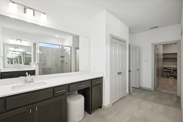 bathroom with vanity and a shower with shower door