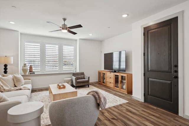 living room featuring hardwood / wood-style flooring and ceiling fan