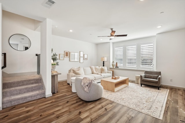 living room featuring ceiling fan and hardwood / wood-style floors