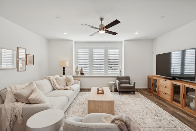 living room with ceiling fan and wood-type flooring