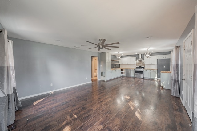 unfurnished living room featuring dark hardwood / wood-style flooring and ceiling fan