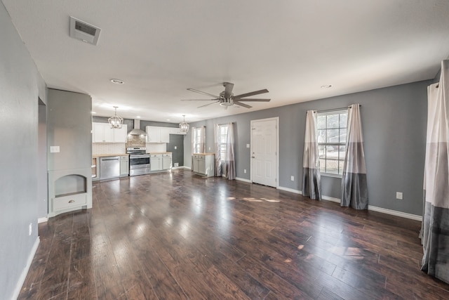 unfurnished living room featuring dark hardwood / wood-style floors and ceiling fan