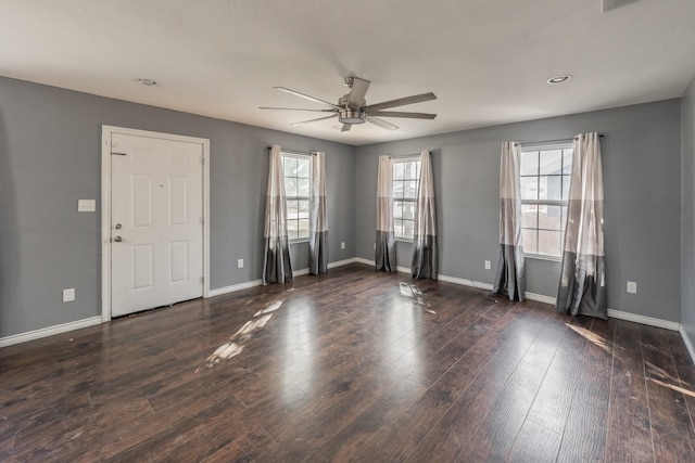 unfurnished room featuring ceiling fan and dark wood-type flooring