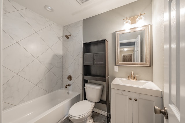 full bathroom featuring vanity, tiled shower / bath combo, and toilet