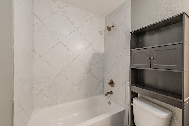 bathroom featuring toilet and tiled shower / bath