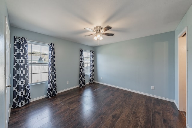 spare room with ceiling fan and dark hardwood / wood-style floors