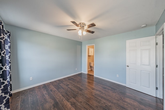 unfurnished bedroom featuring ensuite bath, ceiling fan, and dark hardwood / wood-style floors