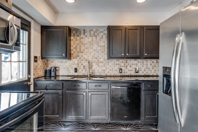 kitchen with tasteful backsplash, dark stone counters, dark brown cabinets, sink, and black appliances