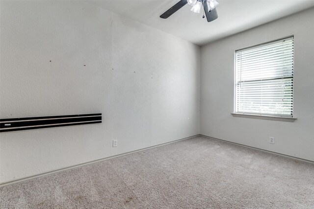 carpeted empty room with ceiling fan and crown molding