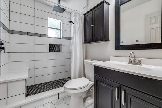 bathroom with tile patterned flooring, vanity, toilet, and walk in shower