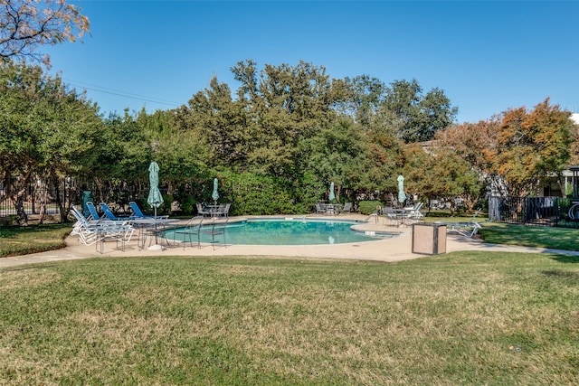 view of pool featuring a yard and a patio