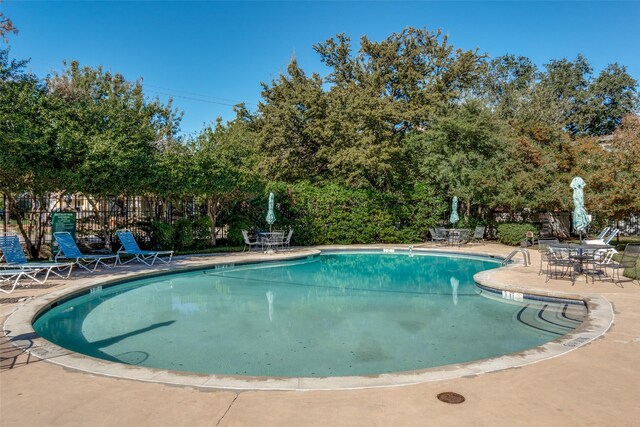 view of swimming pool featuring a patio area