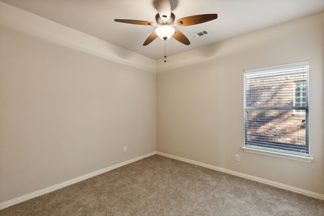 carpeted spare room featuring ceiling fan